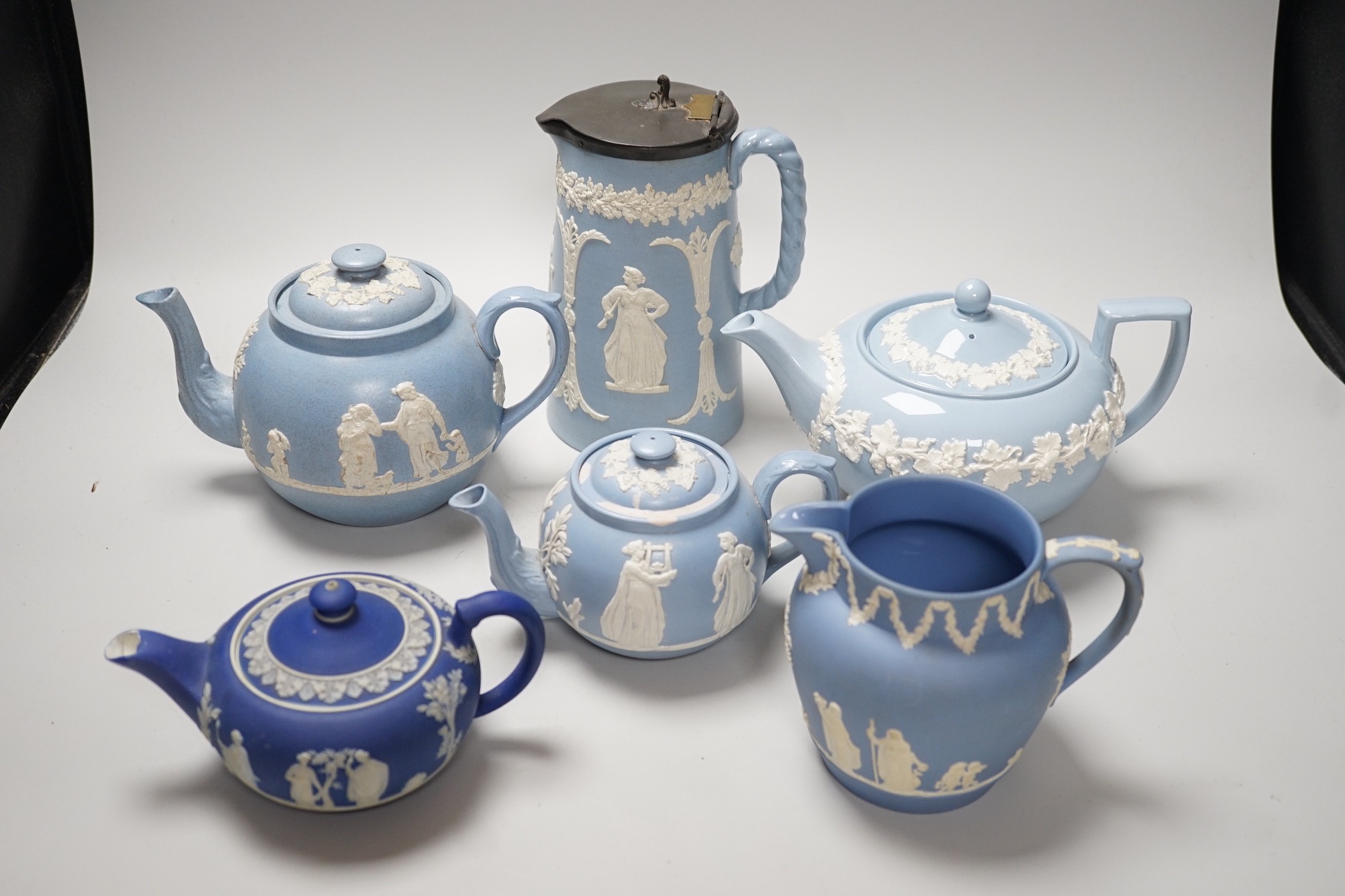 A group of Wedgwood and Wedgwood style jasperware teapots and jugs.
